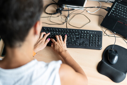 Woman working from home office using computer keyboard