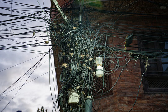 Sparrow makes a nest in wire pole.