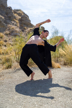Dancer performing contemporary dance outdoors in the desert