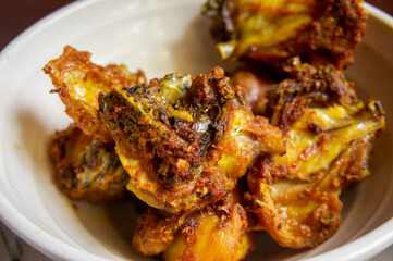 The delicious fried chicken looks very crispy served on a white bowl