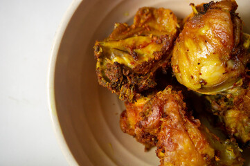 The delicious fried chicken looks very crispy served on a white bowl