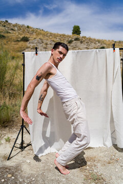 Dancer posing with white backdrop outdoors