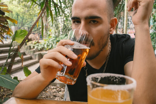 Young Man Drinking Beer at Outdoors