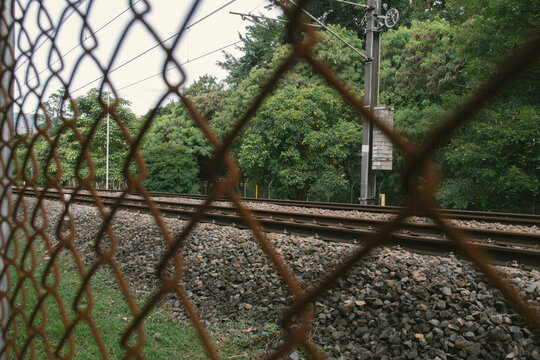 Metro Rails Behind Metal Fence