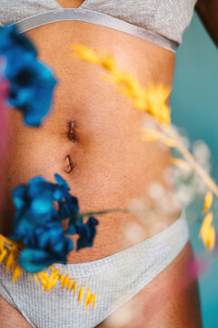 Woman's abdomen with hernia scar on belly