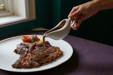 Medium rare T-bone steak with gravy
