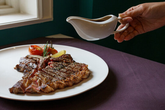 Medium rare T-bone steak with gravy