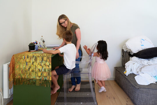Woman Helping Son With Homework in Living Room