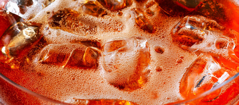 Close Up of Fizzy Orange Spritz Cocktail With Ice Cubes
 - Powered by Adobe