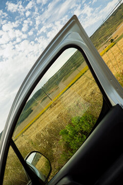 Open Car Door View Of Rural Landscape On Sunny Day