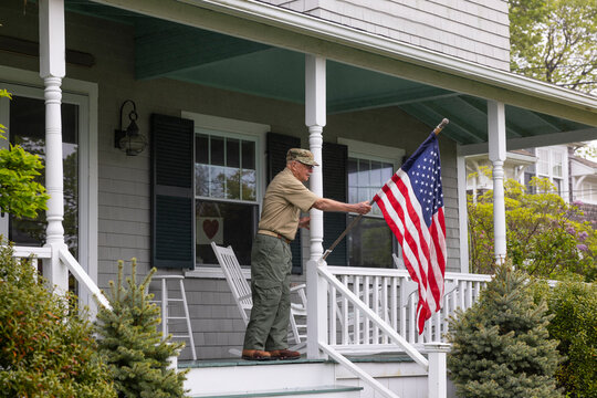 Senior  Veteran display American Flag at House