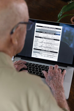 Senior on laptop computer applying for Veteran Medical benefit