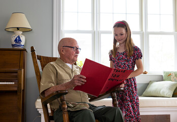 Young Girl give card portrait thanking veteran tribute at home