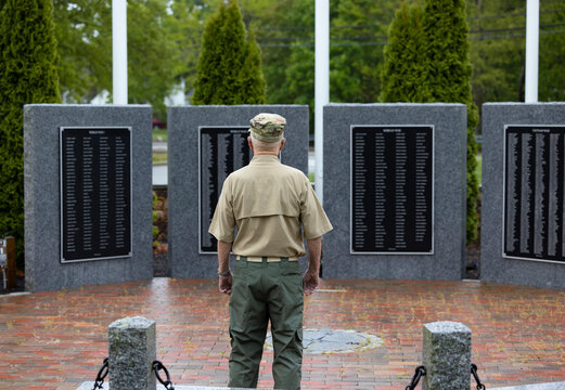 Senior Citizen military man Veteran Portrait  war memorial from back