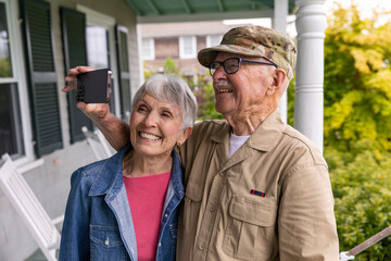 Senior Veteran selfie  Portrait smartphone porch with wife 