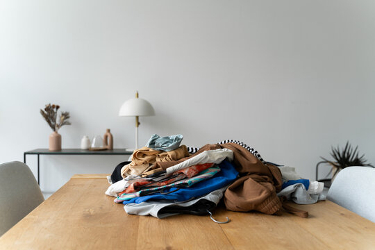 Unfolded Clothes on Table

