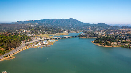 Fototapeta premium Aerial shot of a beautiful bridge in the Bay Area with a mountain beyond, Sausalito