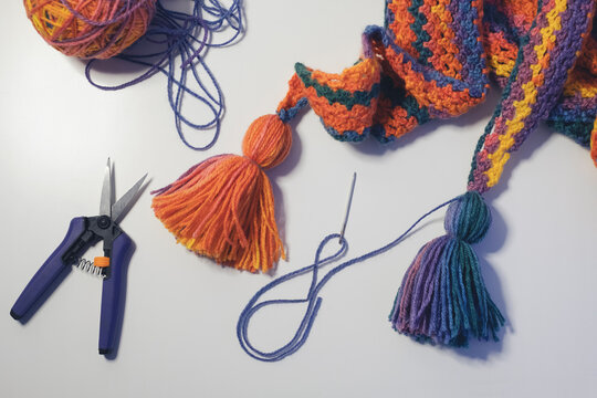 Finishing touches being added to a colourful crochet scarf