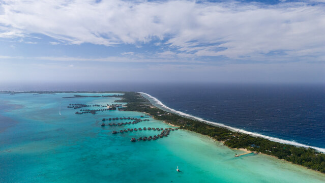 Aerial view of tropical island luxury resorts surrounding the popular tourist destination Bora Bora in French Polynesia. 