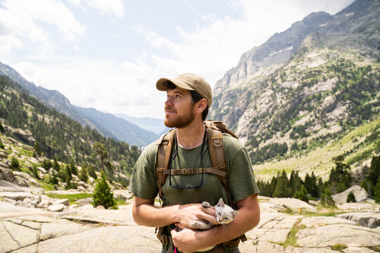Hiker with Cat and Backpack in Mountain