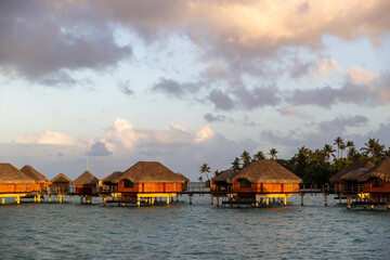 Overwater bungalow hut on a tropical island resort. The popular tourist accommodations are...