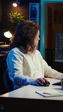 Vertical video Teleworking system administrator futureproofing company network from downtimes and unexpected failures. Remote IT employee typing on keyboard, increasing data security, camera B