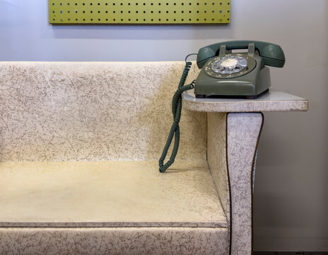 Classic vintage Green Telephone with couch furniture 
