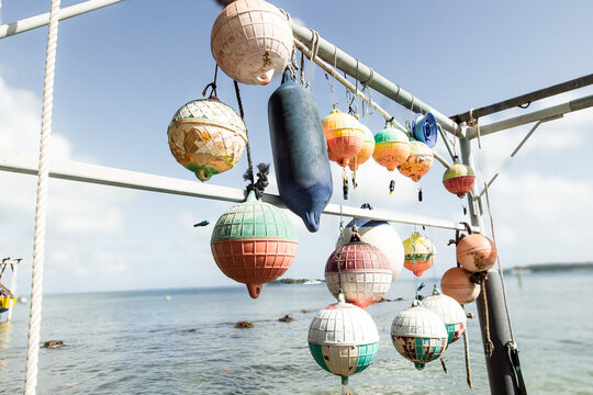 Sun faded colorful buoys for a boat hanging off a pier at tropical island Bora Bora in French Polynesia