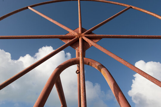 Rusted metal boat lift in south pacific ocean on the tropical island Bora Bora. The steel bars make a shape within a circle including trangle. 