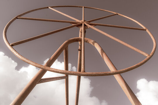 Rusted metal boat lift in south pacific ocean on the tropical island Bora Bora. The steel bars make a shape within a circle including trangle. 