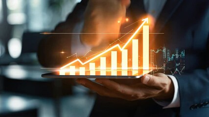 A man is holding a tablet with a graph on it. The graph shows a rising line, which could represent a positive trend or growth. The man's hand is hovering over the graph - Powered by Adobe
