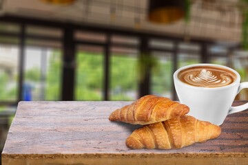 Fresh tasty croissants and coffee in modern kitchen