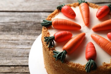 Delicious carrot cake on wooden table, closeup