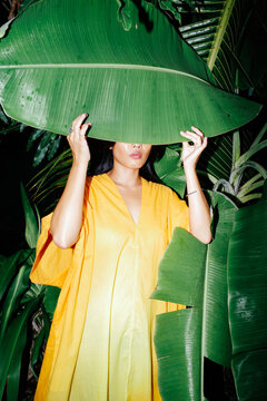 Woman behind banana leaf