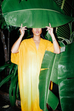 Woman behind banana leaf