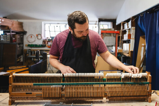 Piano Craftsman Aligning Piano Hammers