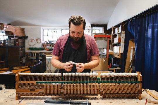 Piano Repair Craftsman Working on Piano Hammers