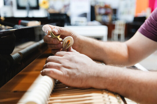 Technician Fine-Tuning Piano Hammer