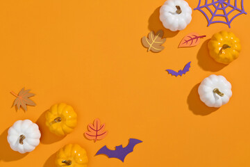 Spooky Halloween pumpkins on orange backdrop.