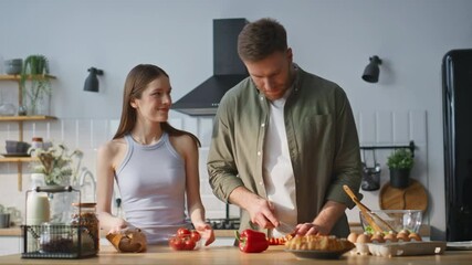 Happy family preparing vegetables in kitchen countertop closeup. Smiling couple  - Powered by Adobe