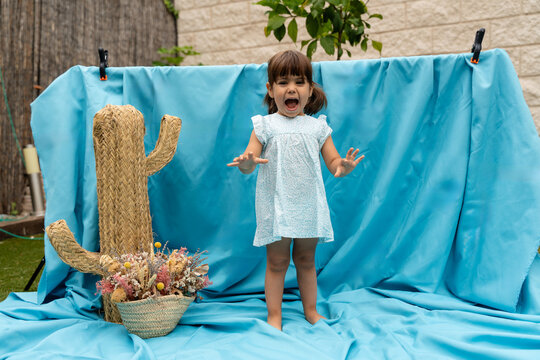 girl screaming and posing in a blue background