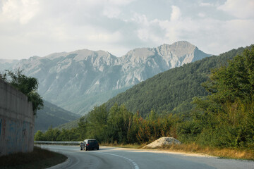 Fototapeta premium Beautiful road among mountains and forests