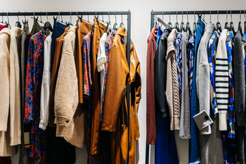 A clothing rack filled with various garments