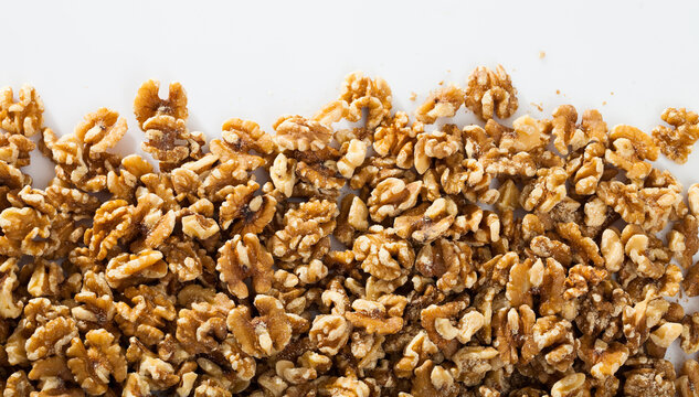 Closeup of raw shelled walnuts on white background. Concept of healthy and nutritious food