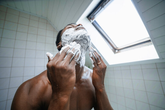 A man applies shaving foam