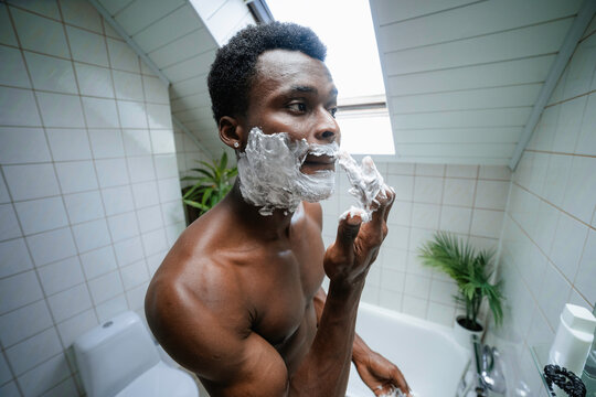 A man applies shaving foam