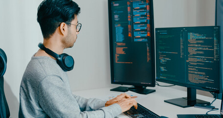 Young adult Asia male freelance eyeglasses typing write prompt AI bot IT app smart program nomad, video game, terminal with coding, user interface, designer, big data center on desktop computer.