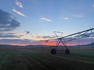 sunset over a hay field