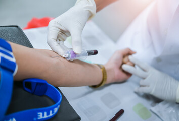 Close up hand of nurse, taking blood sample from a patient in the hospital.	