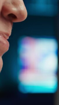 Vertical video Extreme closer up shot of happy computer engineer satisfied after futureproofing company network from system failures. Smiling IT worker pleased after managing to increase data security